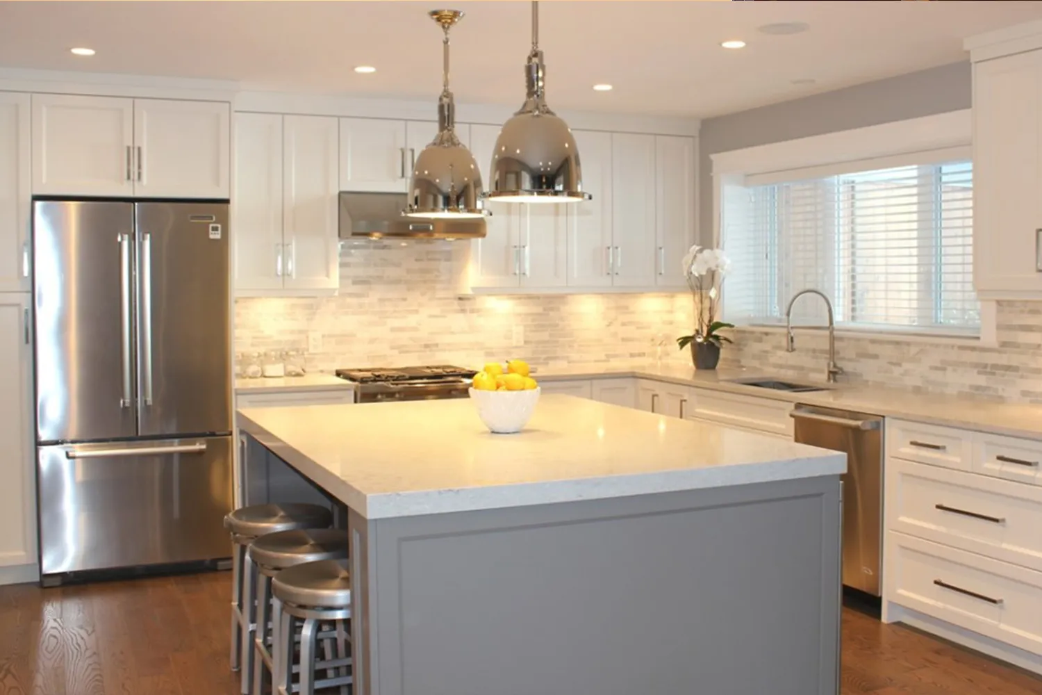 Island and pendant lights in a remodeled kitchen
